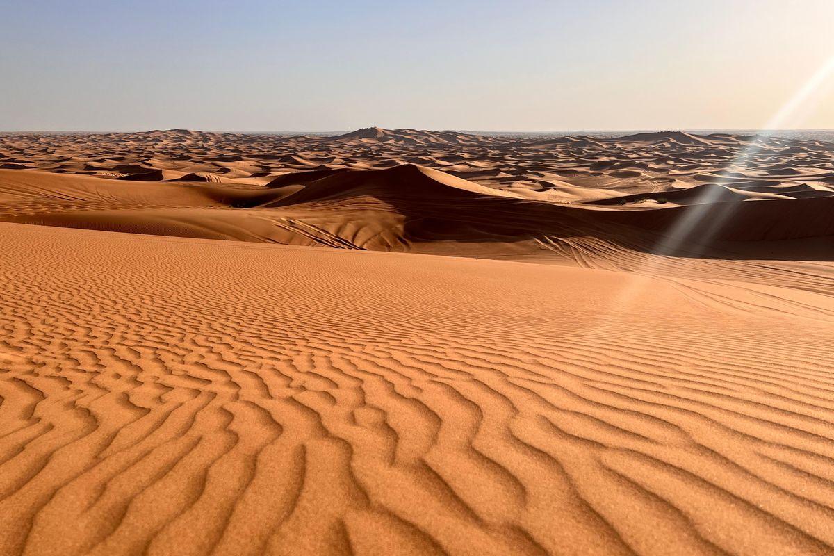 Rippled red sand dunes at Al Lahbab in Dubai desert at golden hour
