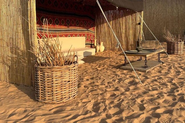 Traditional Arabic majlis tent with floor cushions at a Dubai desert camp