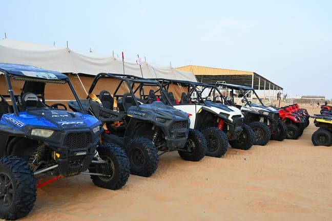 Row of Polaris dune buggies ready for a self-drive ride in the Dubai desert