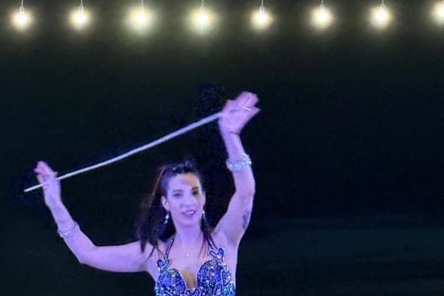 Belly dancer performing at the desert safari camp at night