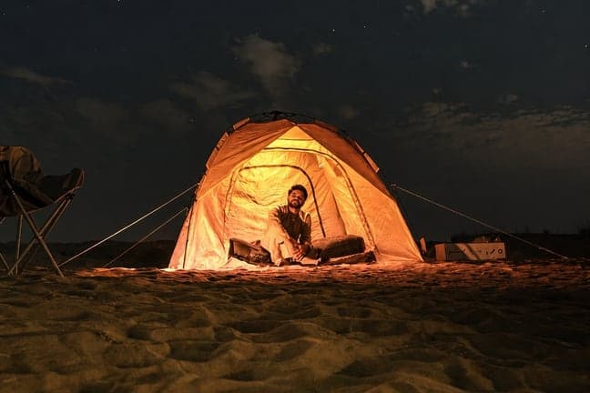 Glowing tent at a Dubai overnight desert camp beneath the stars